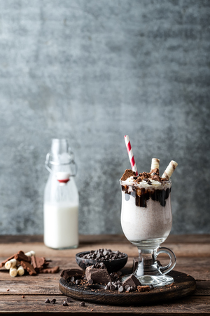 delicious milkshake with ice cream, chocolate and cookiesの写真素材