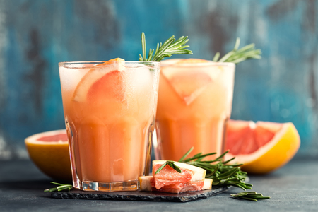 Grapefruit and rosemary gin cocktail or margarita, refreshing drink with iceの写真素材