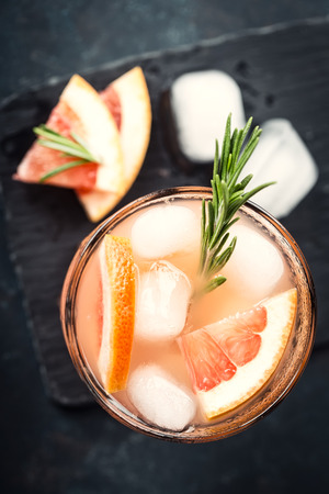 Grapefruit and rosemary gin cocktail or margarita, refreshing drink with iceの写真素材