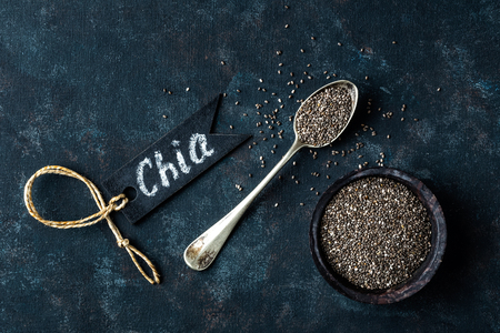 Chia seeds in a stone bowl on a dark backgroundの写真素材
