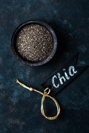 Chia seeds in a stone bowl on a dark backgroundの写真素材