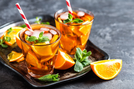 homemade flavored orange iced tea, refreshing summer beverageの写真素材