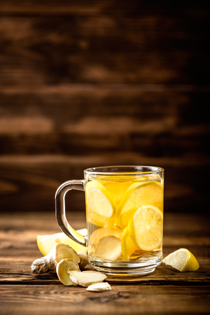 hot sweet ginger tea with lemon in glass mugの写真素材