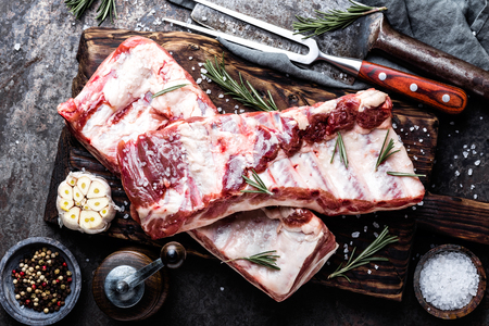raw meat ribs on wooden cutting boardの写真素材