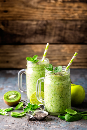 green smoothie with spinach, apple, kiwi, lime and chia seeds. healthy diet eating, superfoodの写真素材