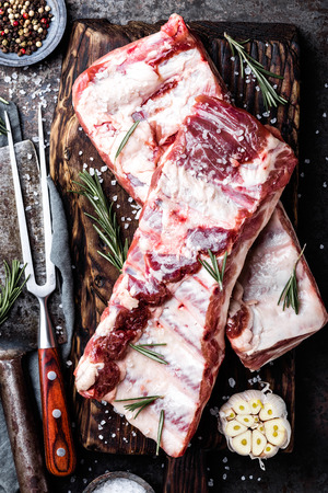 raw meat ribs on wooden cutting boardの写真素材