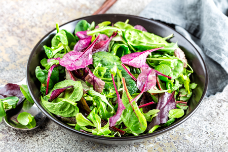 Fresh salad mix of baby spinach, arugula leaves, basil, chard and lambs lettuce. Salad bowl, healthy foodの写真素材