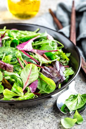 Fresh salad mix of baby spinach, arugula leaves, basil, chard and lambs lettuce. Salad bowl, healthy foodの写真素材