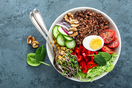 Healthy salad Buddha bowl dish of pepper, tomato, cucumber, chickpea, chia, sprouts, savoy and nuts. Healthy eating trend, superfood. Top viewの写真素材