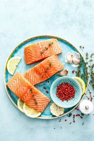 Seafood. Fresh raw salmon or trout fillets with ingredients, top view, space for a textの写真素材