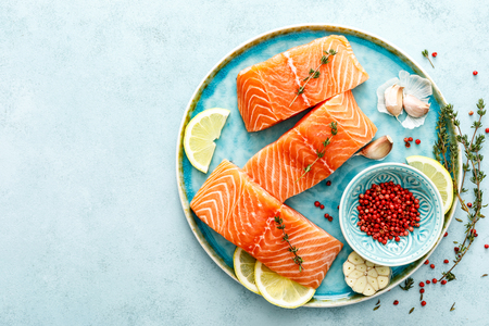 Seafood. Fresh raw salmon or trout fillets with ingredients, top view, space for a textの写真素材