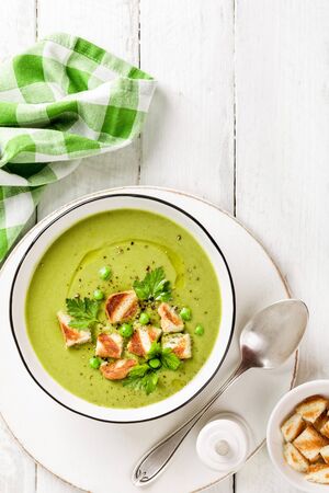 Pea soup. Green pea puree soup in a bowl served with grilled toasts, top viewの写真素材