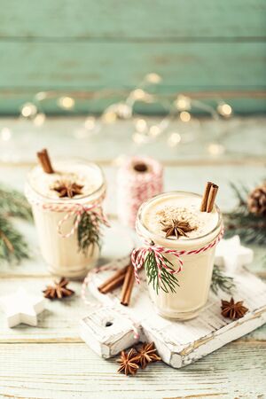 Eggnog. Traditional Christmas drink, spiced egg-milk cocktail with nut topping.の写真素材