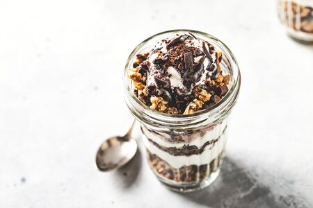 Yogurt parfait with granola, chocolate and ice cream. Sweet delicious breakfastの写真素材