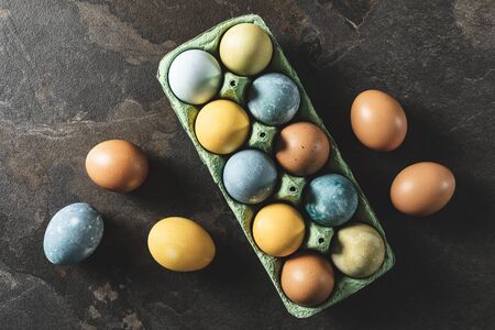 Easter background. Natural dyed easter eggs on dark stone background.の写真素材