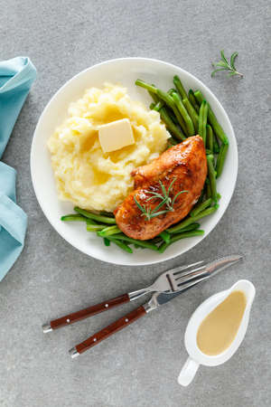Roasted chicken breast with green beans and boiled mashed potatoes. Dinner or breakfast serving.の写真素材