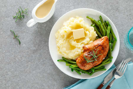 Roasted chicken breast with green beans and boiled mashed potatoes. Dinner or breakfast serving.の写真素材