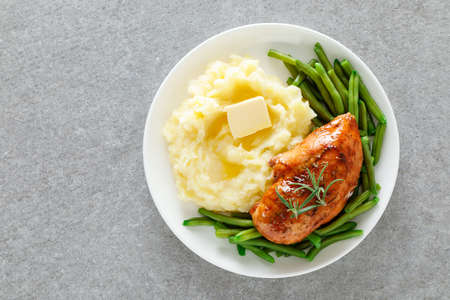 Roasted chicken breast with green beans and boiled mashed potatoes. Dinner or breakfast serving.の写真素材