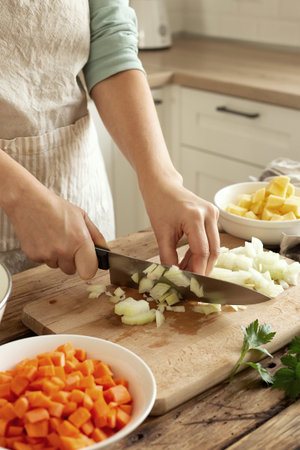 Woman in the kitchen preparing homemade food, female hands working with fresh vegetablesの写真素材
