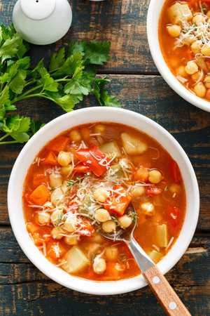 Vegetables soup bowl. Tuscan tomato chickpea soup with various vegetables, thyme and parmesan cheese.の写真素材
