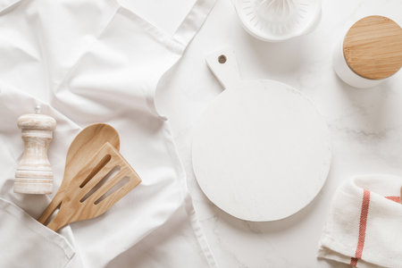 Culinary background, kitchen utensils and apron on kitchen countertop with blank space for any recipe or menu textの写真素材