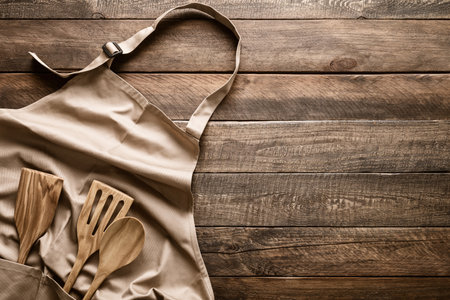 Culinary background, kitchen utensils and apron on kitchen countertop with blank space for any recipe or menu textの写真素材