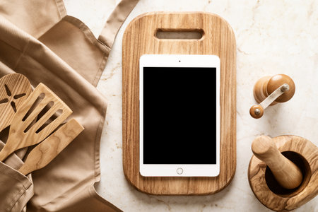 Culinary background, kitchen utensils and apron on kitchen countertop with blank space for any recipe or menu textの写真素材