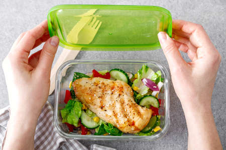 lunch box of vegetable salad with grilled chicken breastの写真素材