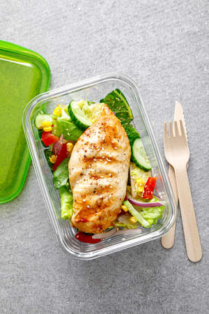 lunch box of vegetable salad with grilled chicken breastの写真素材