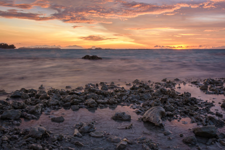 The sea and the dramatic twilight sky on rocky beach at Royal Islandの写真素材