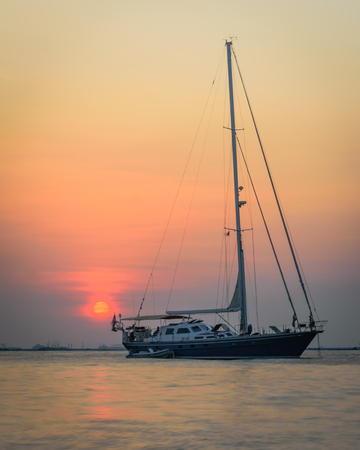 A boat with a colorful sunset sky at Mutiara Beachの写真素材