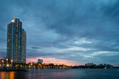 Jakarta, Indonesia - December 9, 2017 : Beautiful scene of Ancol Mansion with orange sky and smooth water at dusk time taken from Love Bridge Ancolのeditorial素材