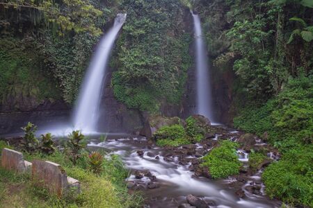 The twin waterfalls that part of beauty of Raung Mountain Sloves, Kalibaru Wetan Village, Banyuwangi Regency, Indonesia. Tirto Kemanten in Javanese means water bride or wedding couple of water.の写真素材