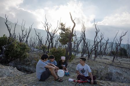 Garut, Indonesia - August 12, 2018 : A group of young people are enjoying and hiking Papandayan Mountain. Papandayan Mountain is one of the favorite place to hike on Garut.のeditorial素材