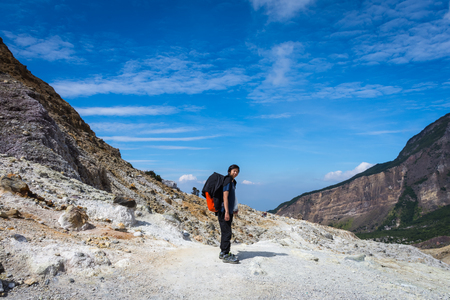 Garut, Indonesia - August 12, 2018 : A man are enjoying and hiking Papandayan Mountain. Papandayan Mountain is one of the favorite place to hike on Garut.のeditorial素材