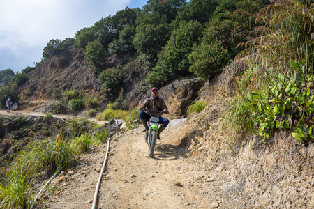 Garut, Indonesia - August 12, 2018 : A local are riding motorcycle on Papandayan Mountain. Papandayan Mountain is one of the favorite place to hike on Garut.のeditorial素材