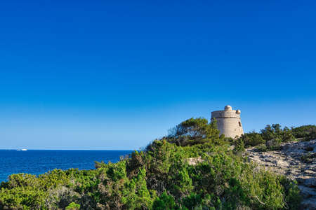 IBIZA, SPAIN, March 2021, round stone tower kind of defensive wall on spanish island coastのeditorial素材