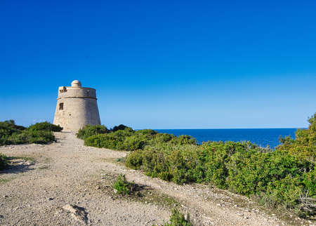 IBIZA, SPAIN, March 2021, round stone tower kind of defensive wall on spanish island coastのeditorial素材