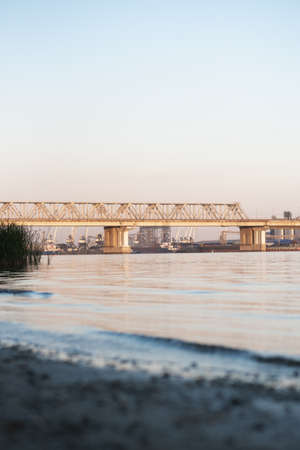 Beautiful railway bridge on the background of the bay at sunset. High quality photoの写真素材
