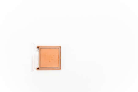 Peach shades face powder in compact square case isolated on white background. Beauty conceptの写真素材