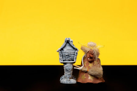Happy Halloween. Baba Yaga with a hut on chicken legs on a yellow background. Isolated space for your text.の写真素材