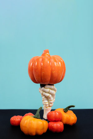 Happy Halloween. Hand of a witch with a big pumpkin on a blue backgroundの写真素材