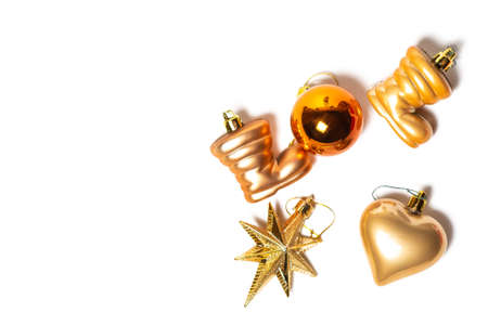 Christmas decorations in gold color on a white background. Red box and Christmas toys. Merry Christmas postcard, frame. Winter holiday theme. Happy New Yearの写真素材