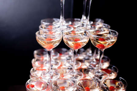 Champagne pyramid with cherries in dark colorsの写真素材