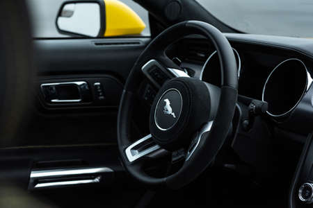 Yellow with black stripes muscle car Ford Mustang. Salon interior, steering wheel close-up. Russia, Rostov-on-Don 23 Oct2021のeditorial素材