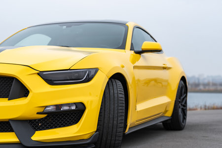 Yellow with black stripes Ford Mustang muscle car in a parking lot. Russia, Rostov-on-Don 23 Oct2021のeditorial素材