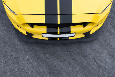 The hood of a yellow car with black stripes. view from above. Asphalt background. Russia, Rostov-on-Don 23oct2021のeditorial素材