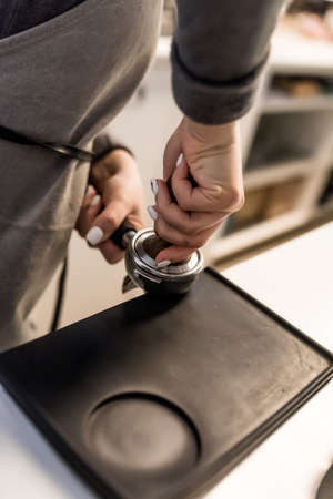 Cafe barista prepares coffee. Worker brewing coffee on a steam espresso machineの写真素材