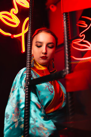 Beautiful girl in kimono. The image of a geisha, Chinese national costume. background neon. Party concept, night club. Russia, Rostov-on-Don 5feb2022のeditorial素材