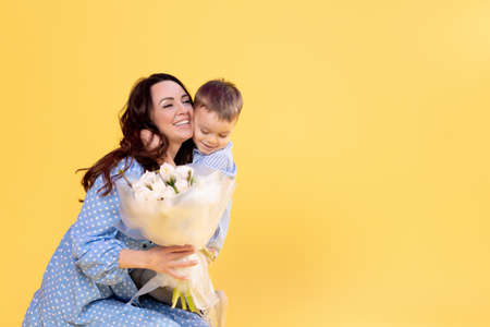 Beautiful mommy plays with cute little son. Happy mother spending time with laughing little childの写真素材